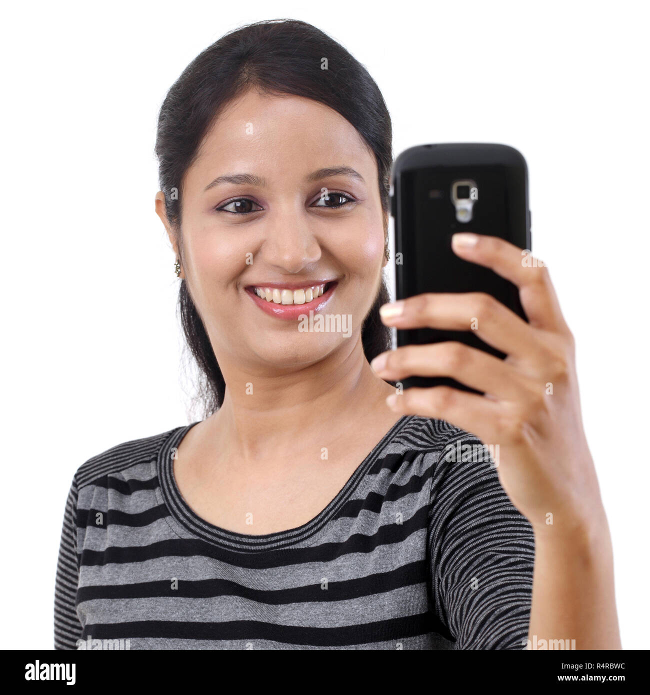 Happy young woman taking a selfie Stock Photo - Alamy