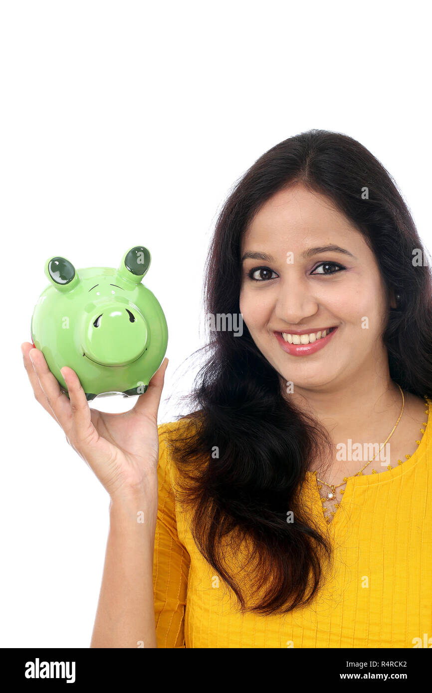 Young Indian Woman Saves Money in Piggy bank Stock Photo