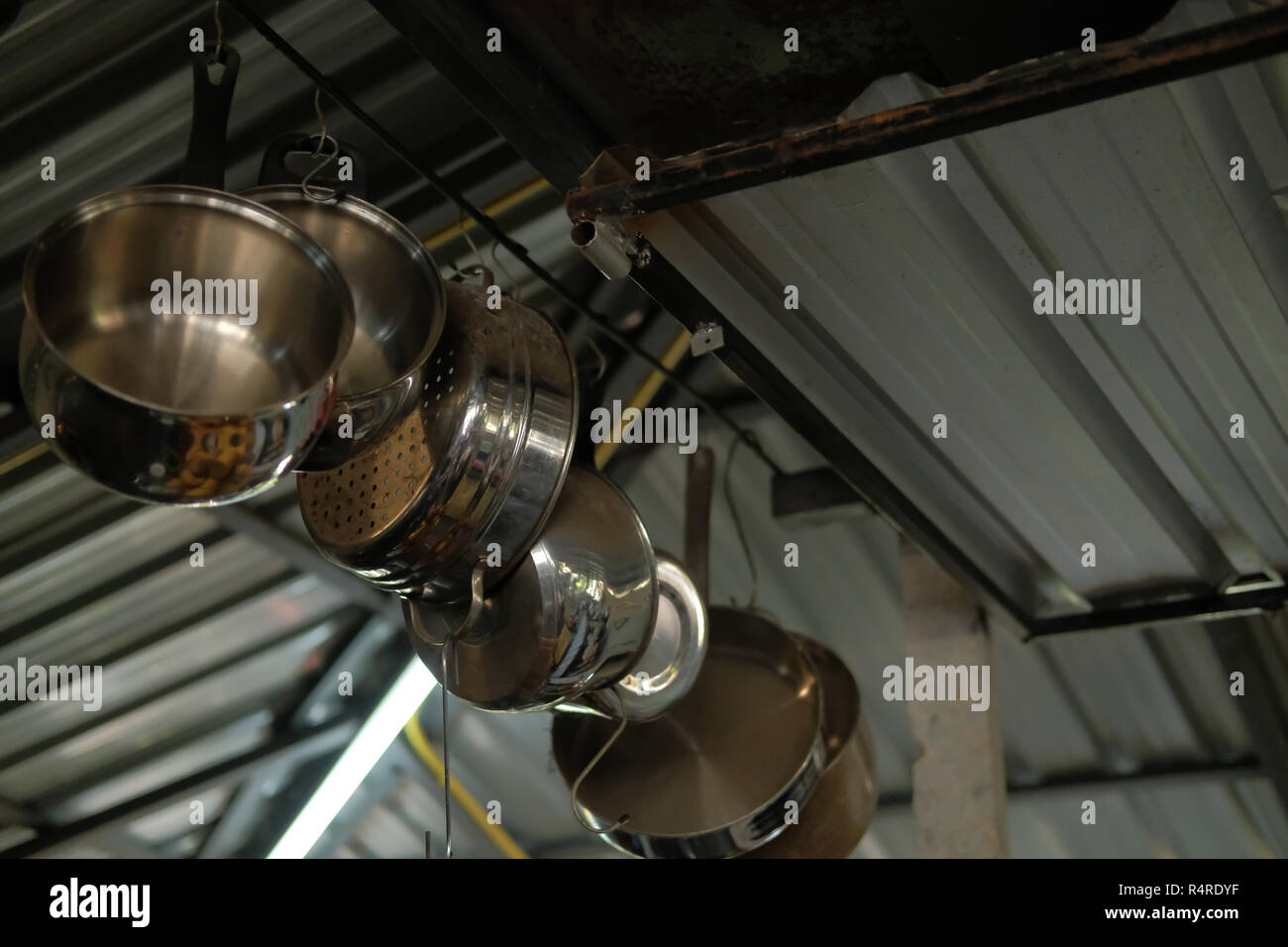 Metal Cooking Pot Hanging On Kitchen Ceiling Stock Photo