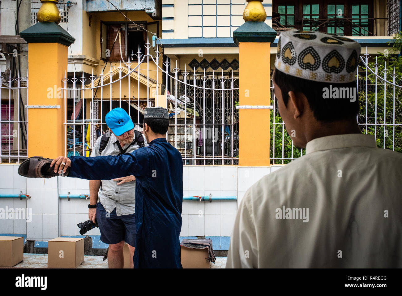 A foreign traveler asking directions at the Joon Mosque, Mandalay, Myanmar Stock Photo