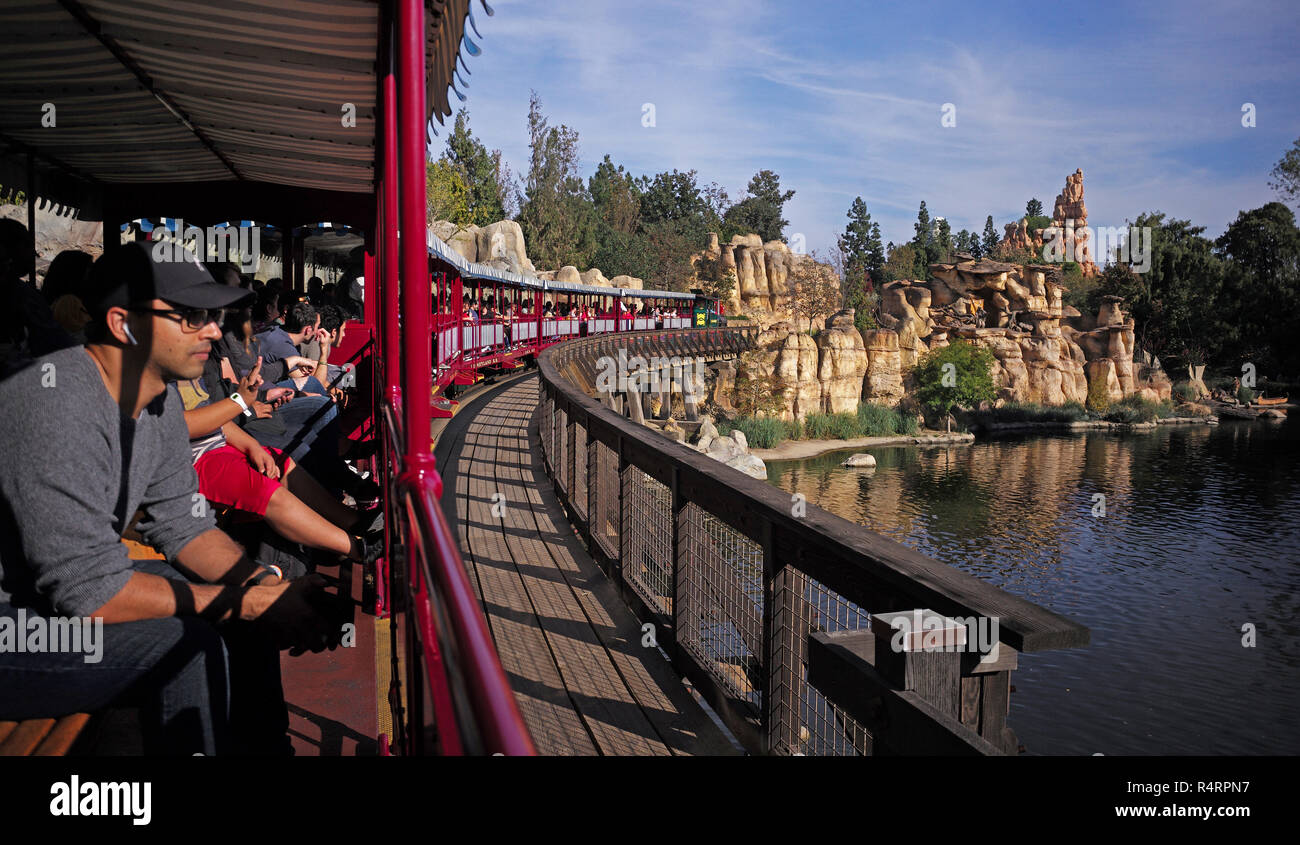 Disneyland railroad traverses through Frontierland near Big Thunder Mountain ride. Stock Photo