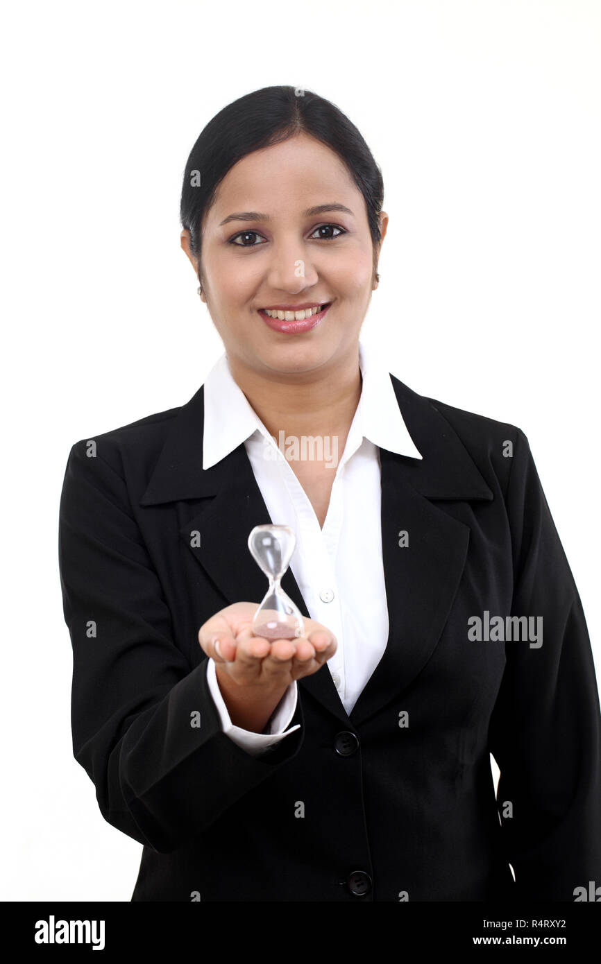 Business woman holding hourglass against white Stock Photo
