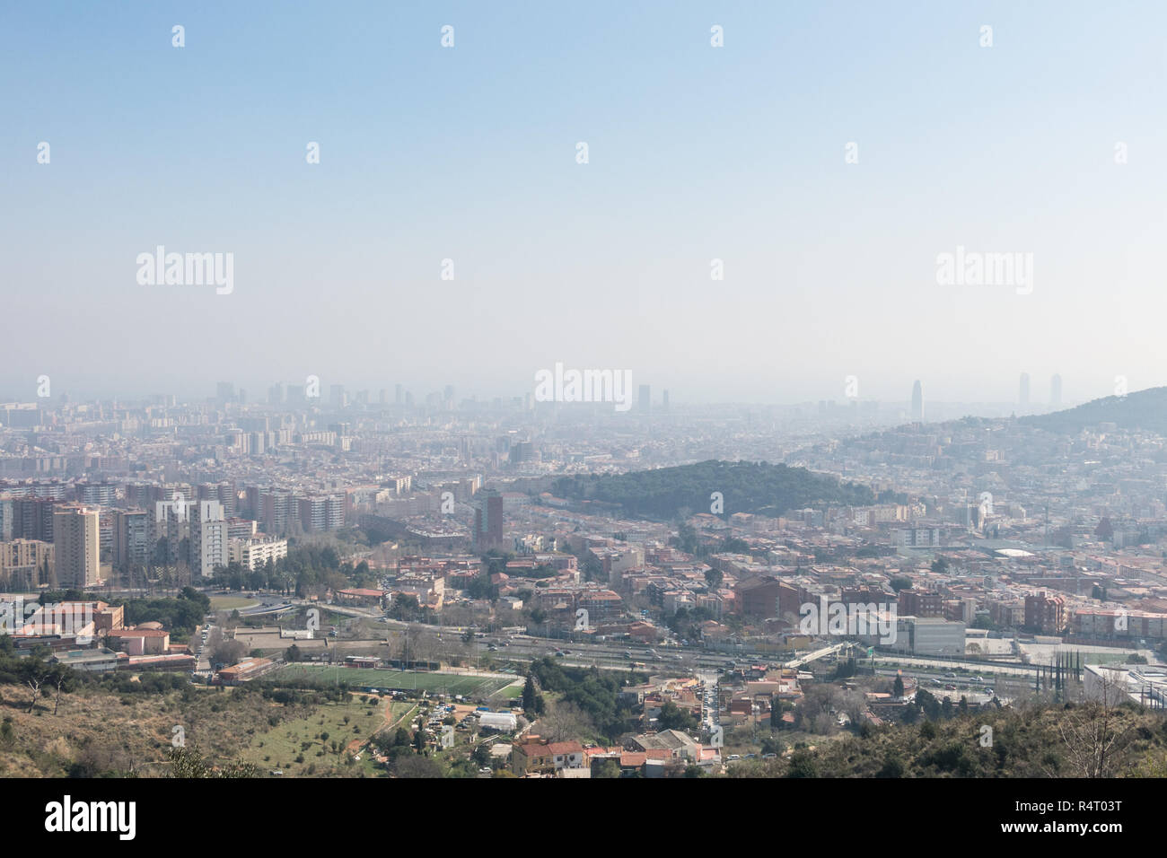 Overview of the polluted city of Barcelona, from the Collserola mountain, with a layer of smog over it. Barcelona, Catalonia, Spain Stock Photo