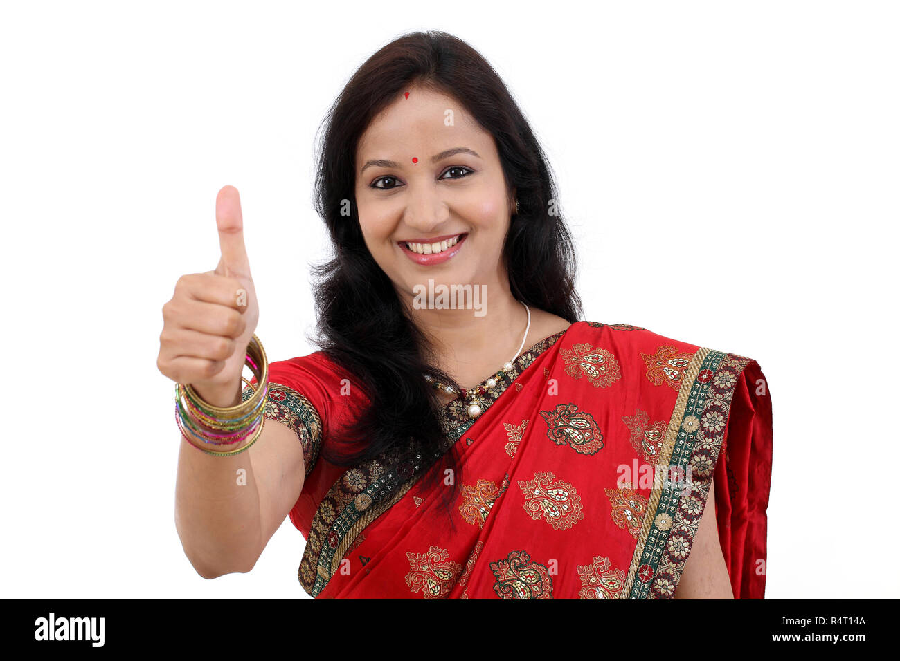 Cheerful traditional young Indian woman showing thumbs up gesture Stock ...