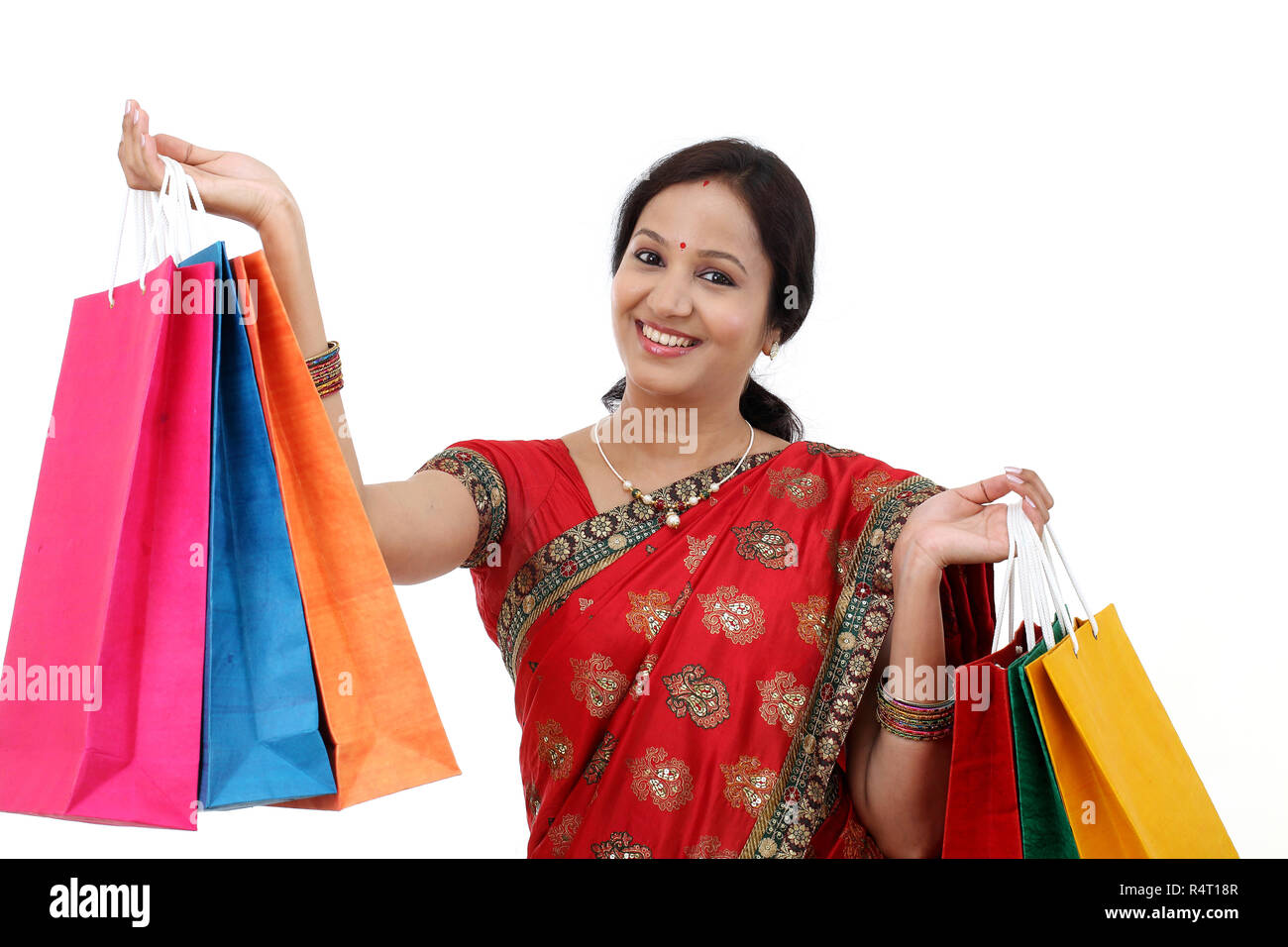 Young traditional Indian woman holding shopping bags Stock Photo