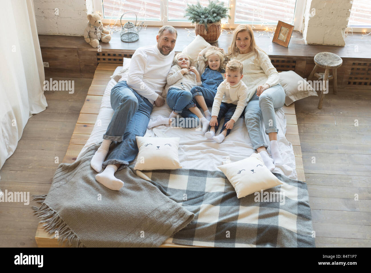 Happy family is lying on the bed and having fun Stock Photo - Alamy