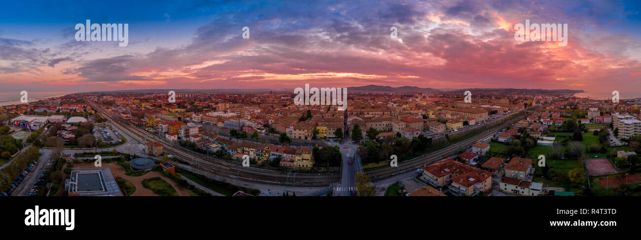 Aerial panorama of popular travel destination beach town Fano in Italy with sunset blue, red, purple sky near Rimini in the Marche region. Stock Photo