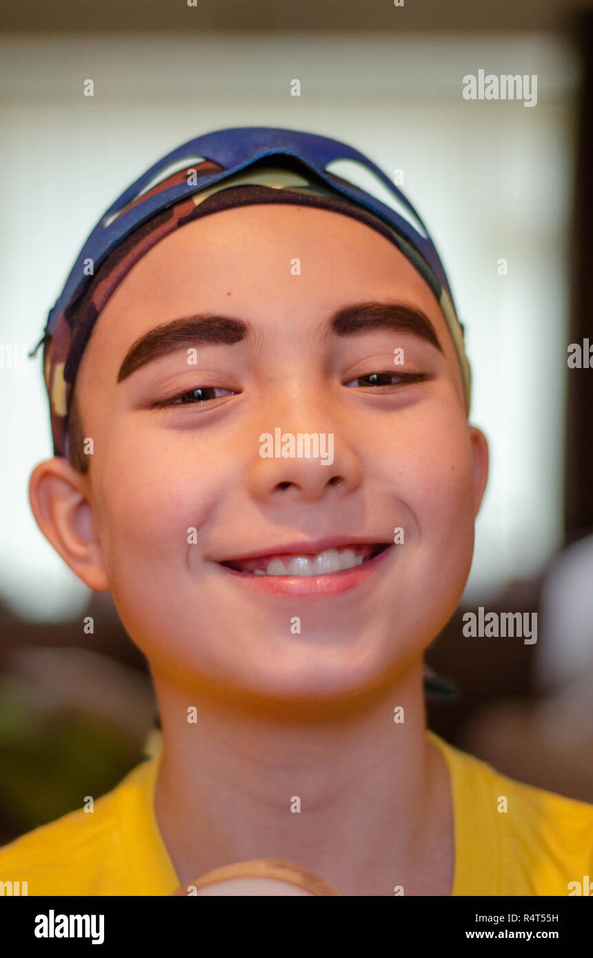 portrait of a boy dressed up as a pirate, wearing eyeliner to make his eyebrows more prominent. Stock Photo