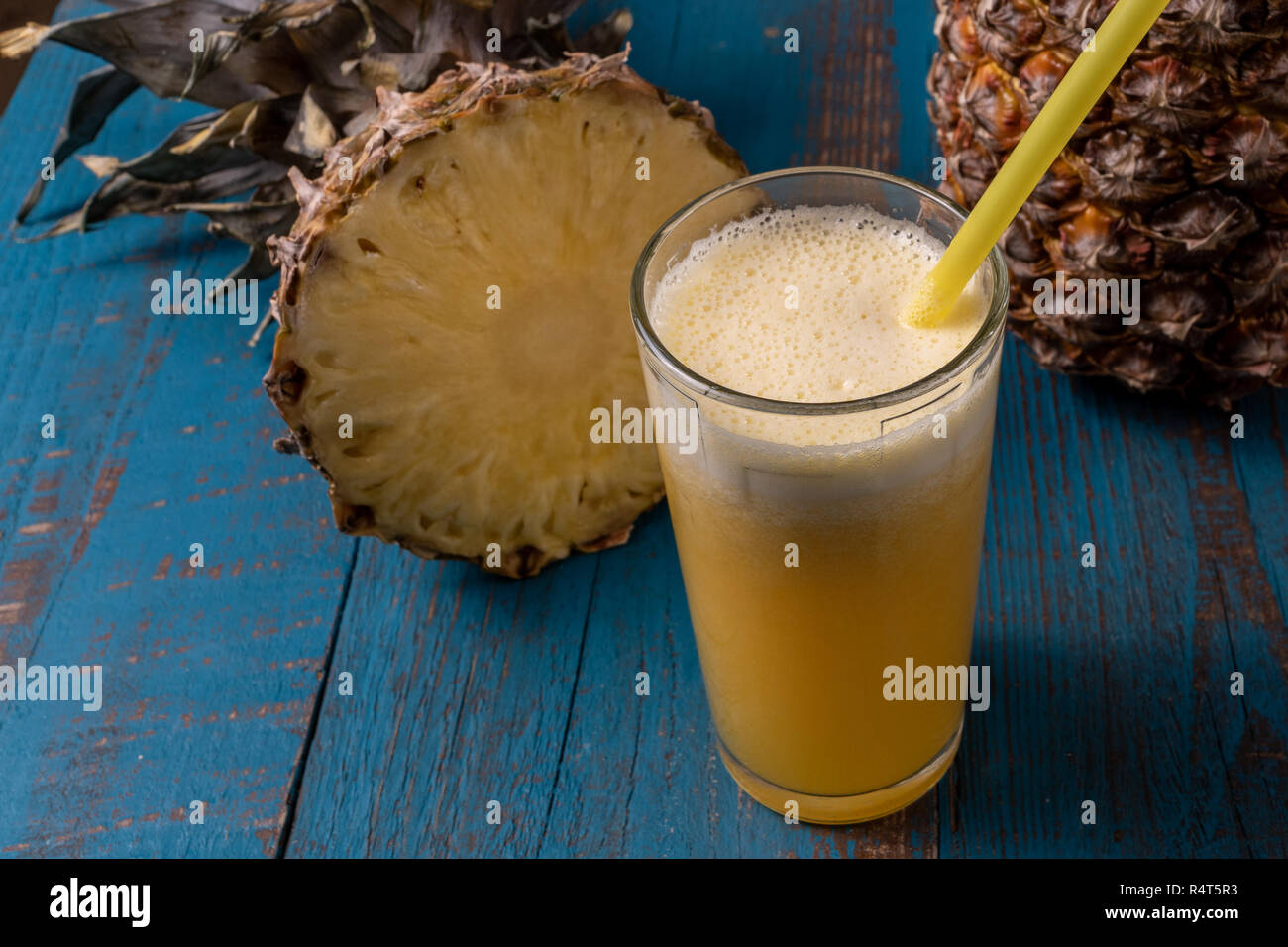Front view the glass of pineapple juice and pineapple fruit over white ...