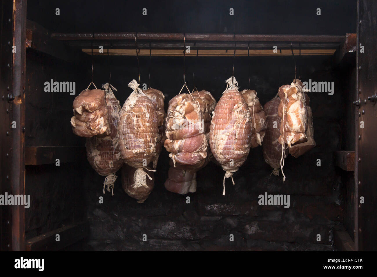 raw meat in a smokehouse. stages of smoking Stock Photo Alamy