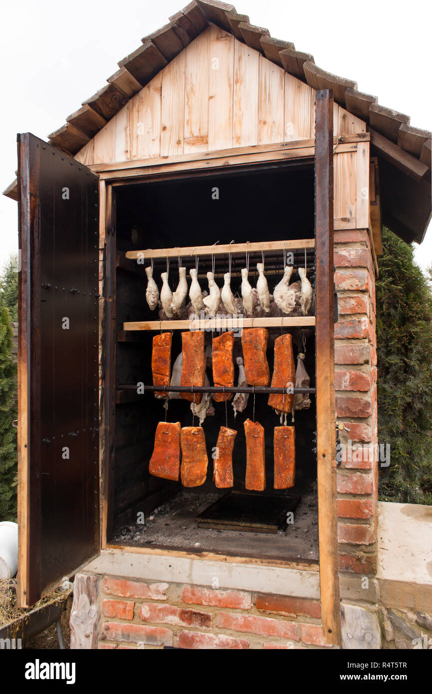 raw meat in a smokehouse. stages of smoking Stock Photo - Alamy