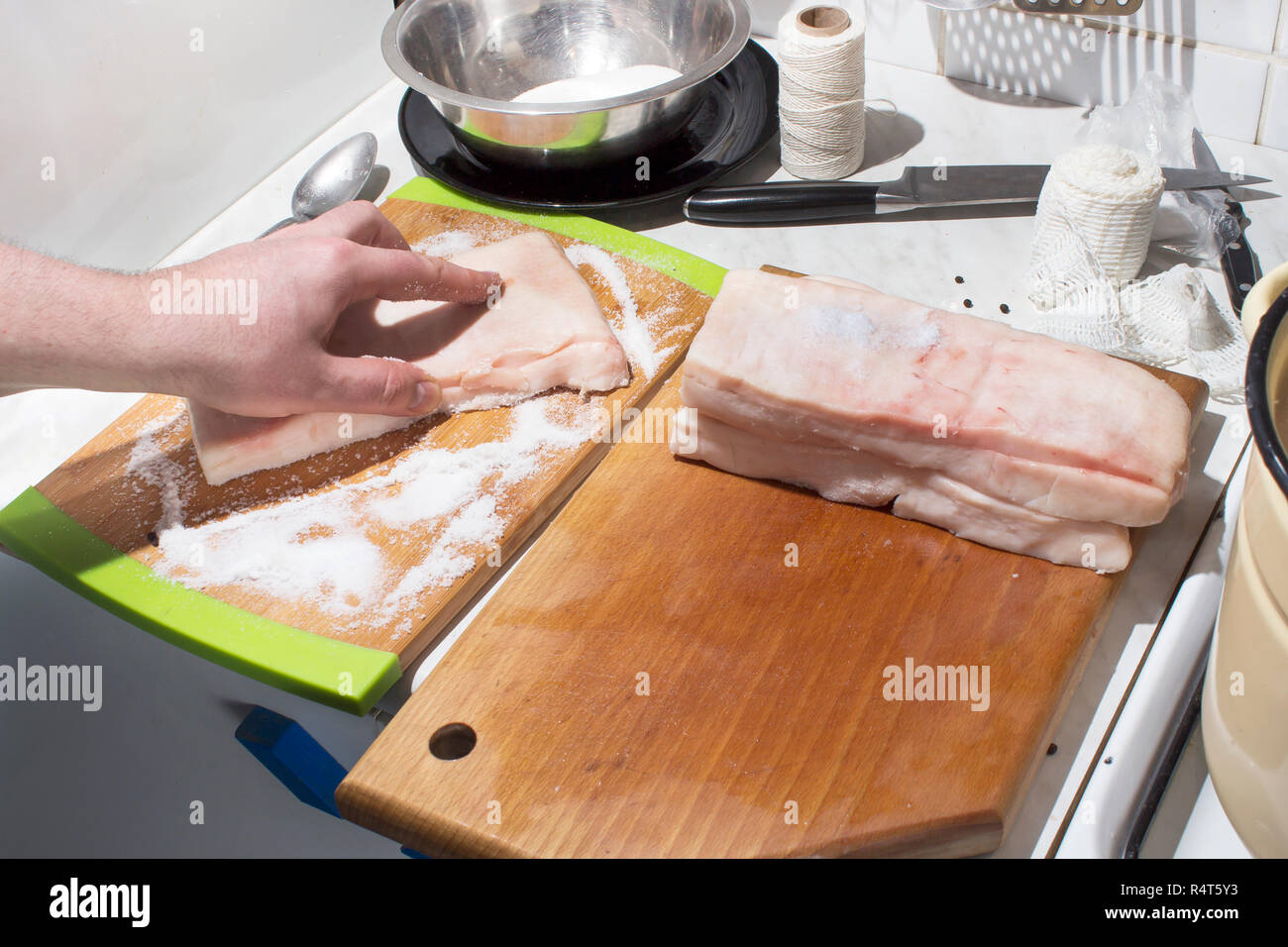 preparation raw meat for smoking. pork neck meat and bacon. salting of raw meat Stock Photo