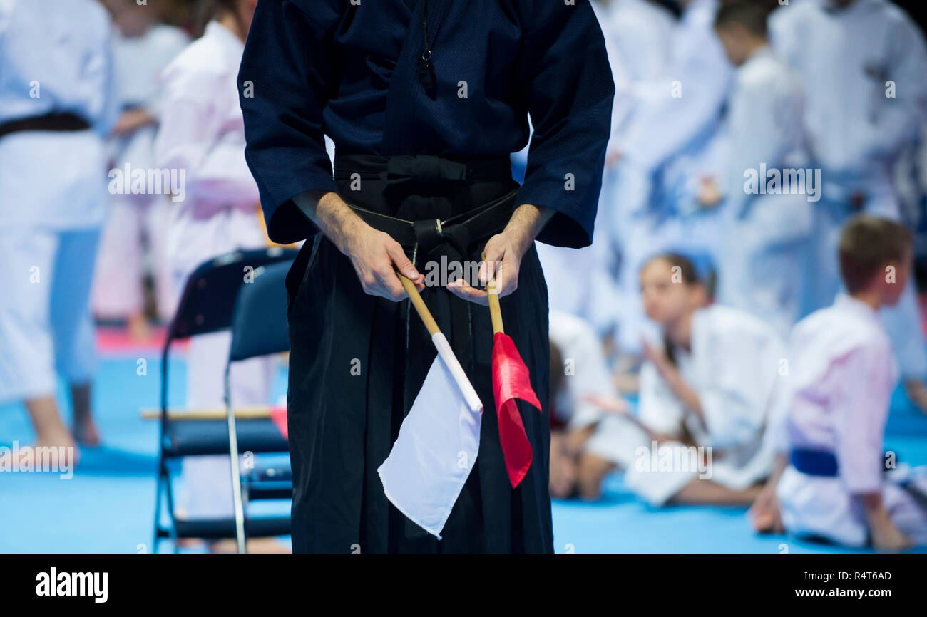 Karate referee with red and white flags Stock Photo Alamy