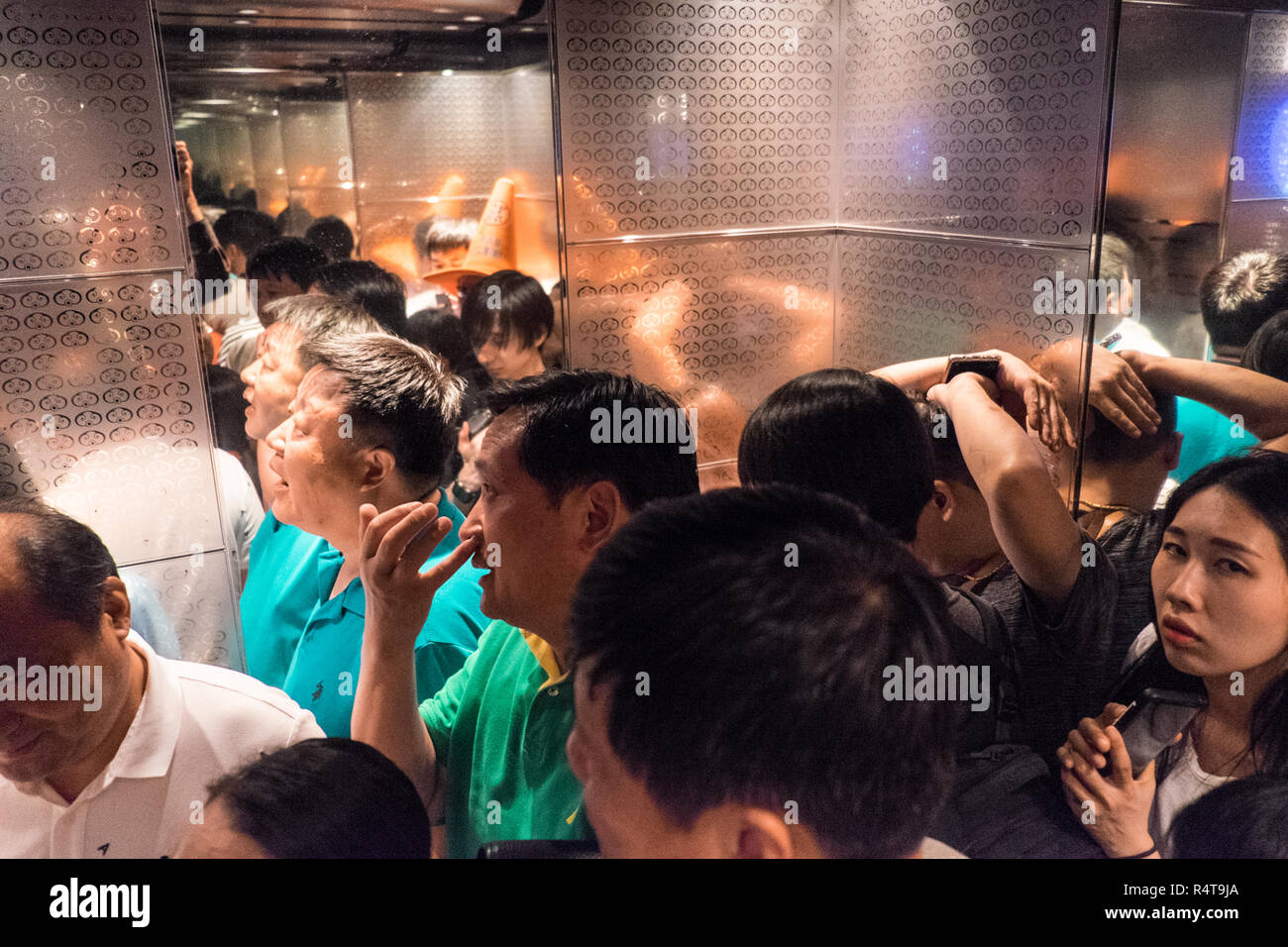 Tourist,tourists,in,lift,elevator,one,of,worlds fastest,on,way,down,from,observatory,tower,at,Taipei 101 Tower,Taipei,Chinese,China,Republic o China, Stock Photo