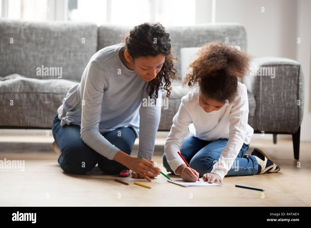 Attractive African American mother coloring with daughter Stock Photo