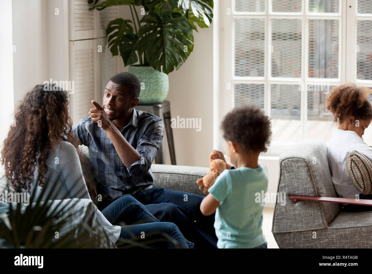 African American couple quarrelling at home on couch Stock Photo - Alamy