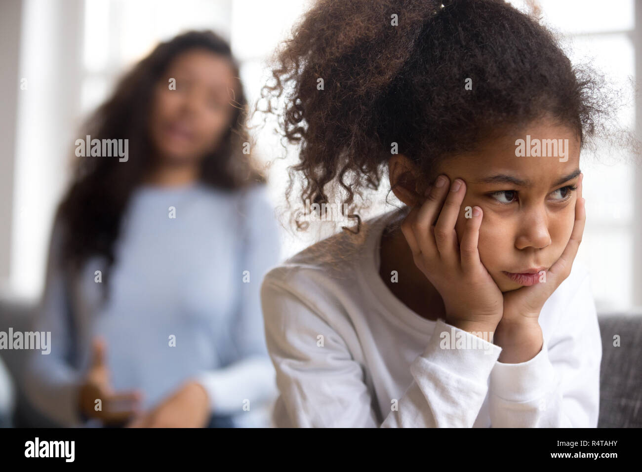 Offended African American preschooler girl looking in distance Stock Photo