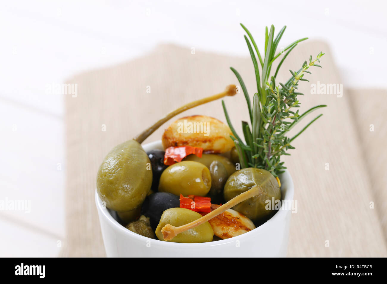 pickled olives, capers, caper berries and garlic Stock Photo Alamy