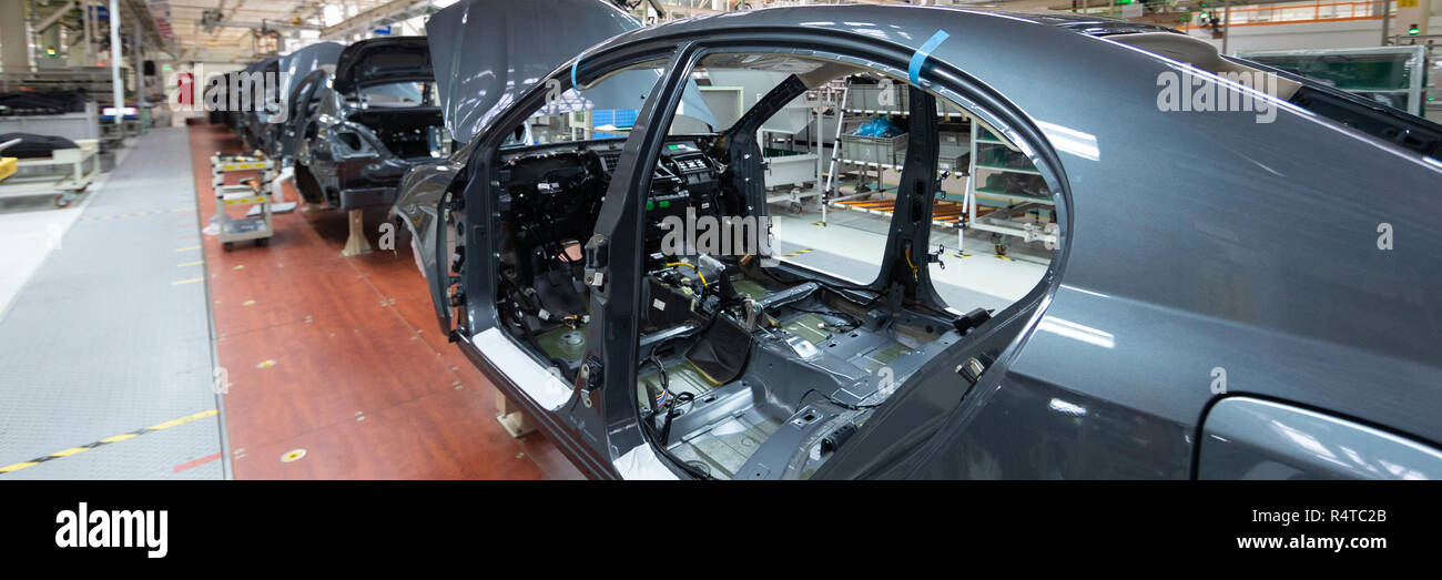 frame of car body. Long format. Wide angle view of plant of automotive industry. Can be used as banner Stock Photo