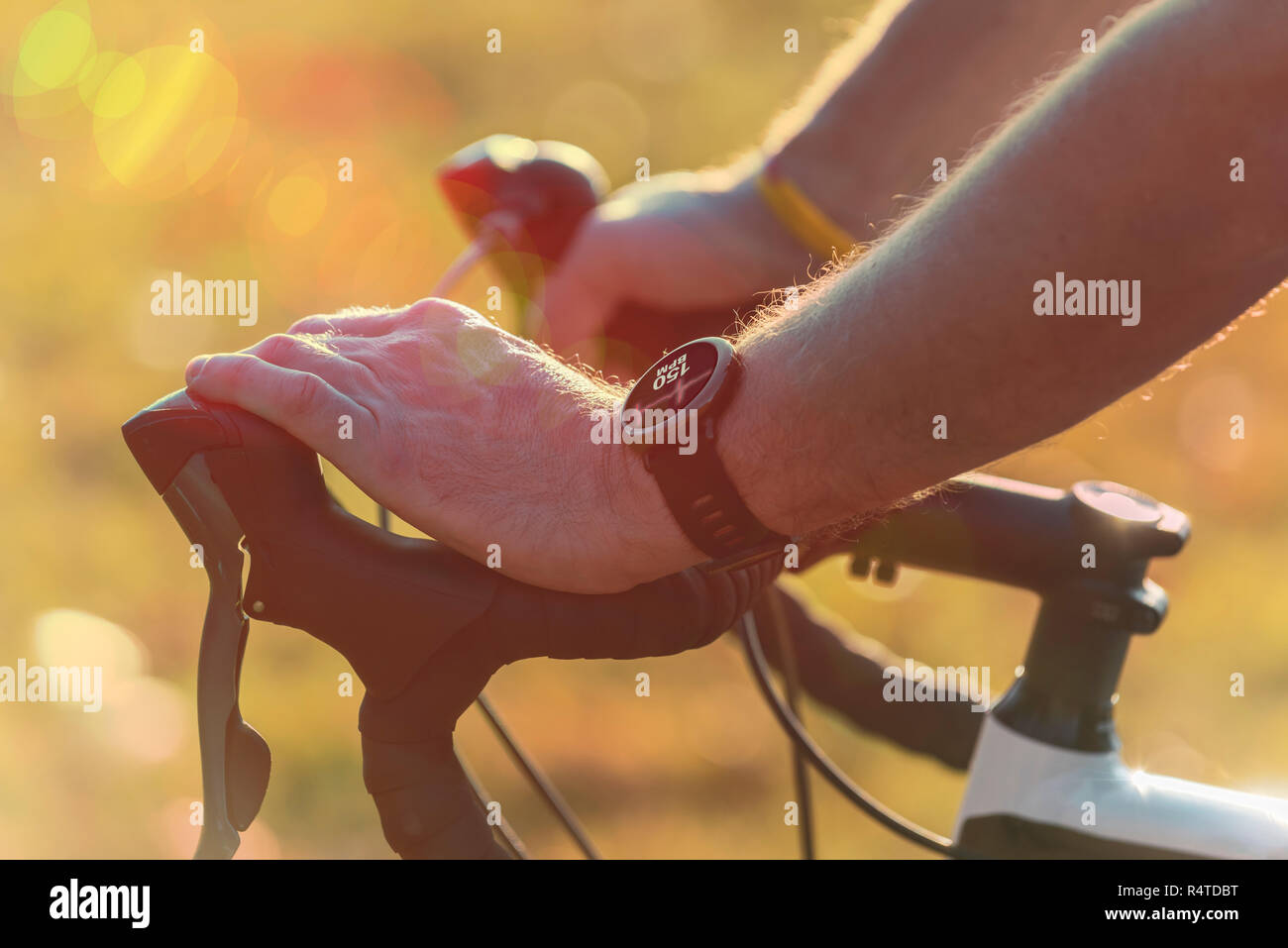 Man riding a bike and using smartwatch to heart rate monitor Stock ...