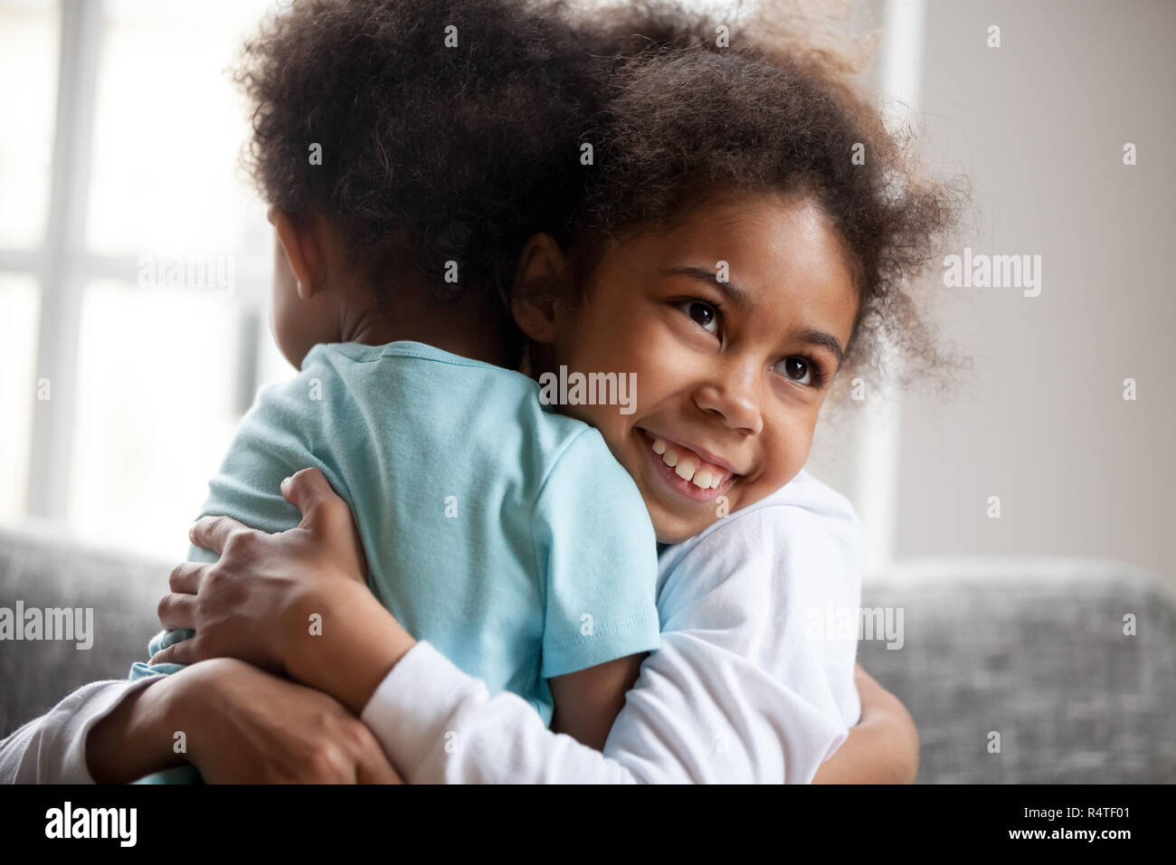 African American little girl embrace adorable brother Stock Photo