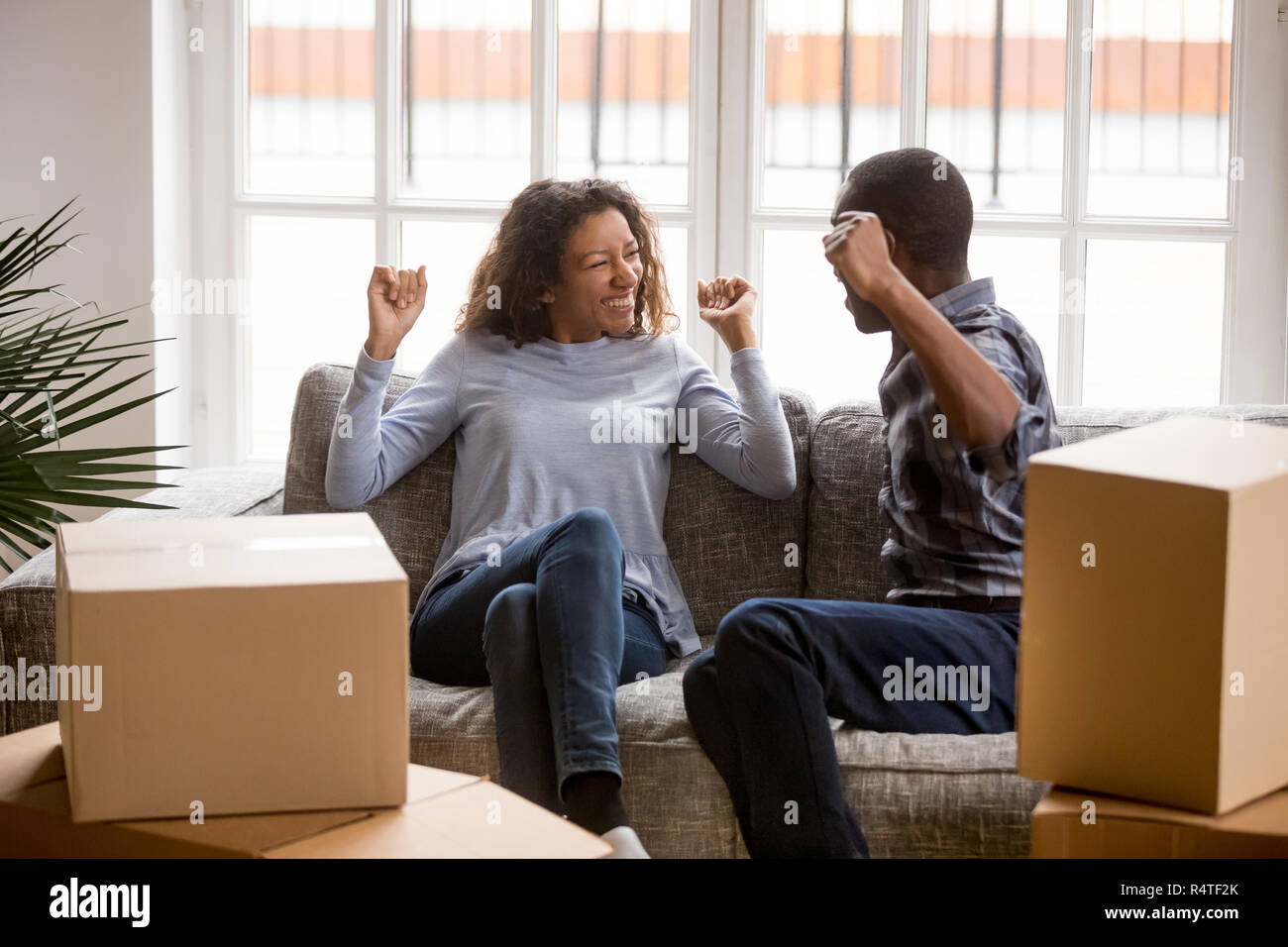 Happy African American couple in love celebrating moving Stock Photo ...