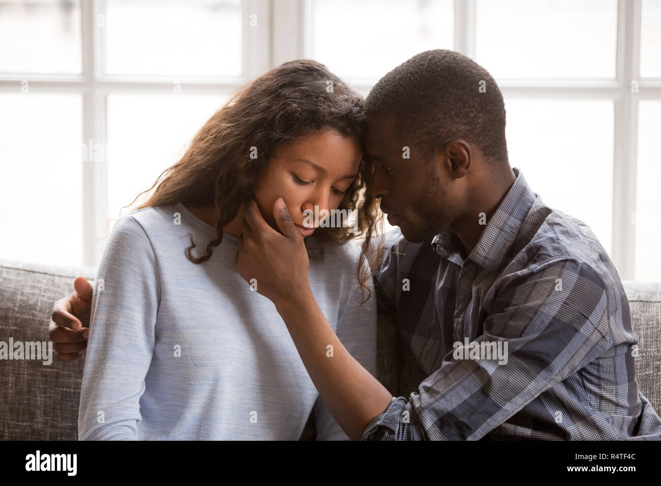 Loving African American husband touching wife face Stock Photo
