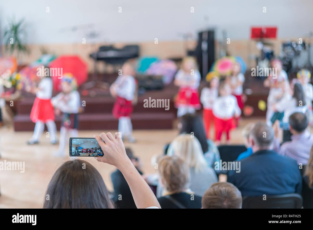 Children's holiday in kindergarten. Children on stage perform in front ...