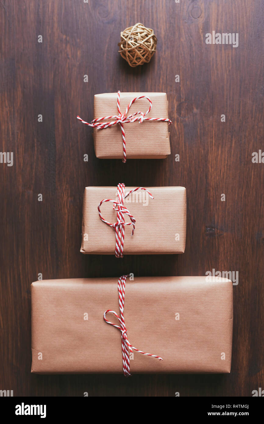 Wrapped Christmas presents arranged in the shape of a tree with a rubber band ball star atop Stock Photo