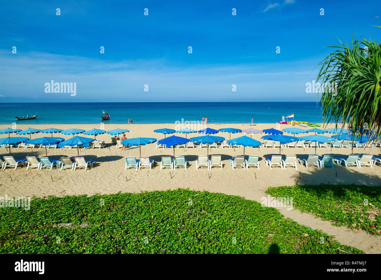 Neatly lined up beach chairs and umbrellas at Karon Beach, Phuket, Thailand, one of the island's most popular beaches Stock Photo