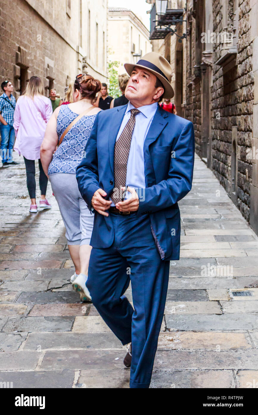 Barcelona, Spain - 4th October 2017: Elegantly dressed man admiring the old buildings in the Gothic quarter. Tourists flock to this area of the city. Stock Photo