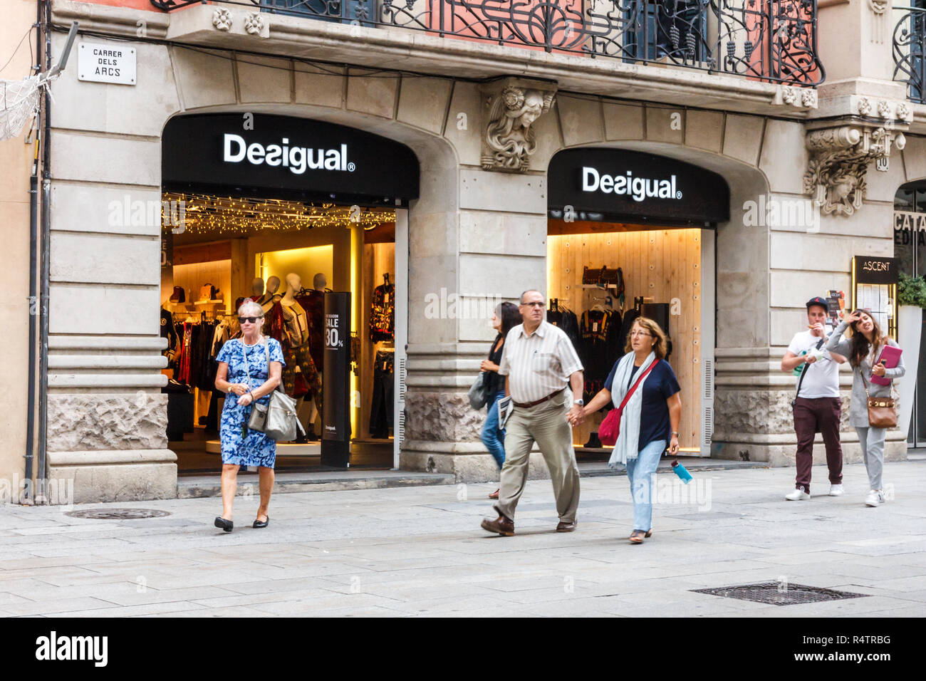 Barcelona, Spain - 4th October 2017: People walking past the Desigual store. The brand is headquartered in the city. Stock Photo