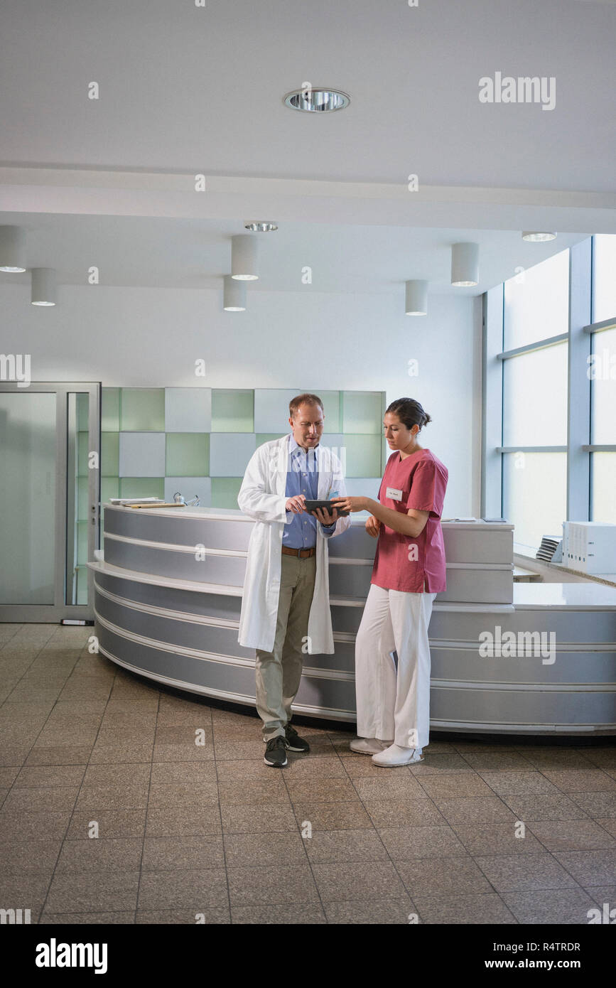 Doctors using digital tablet in hospital Stock Photo
