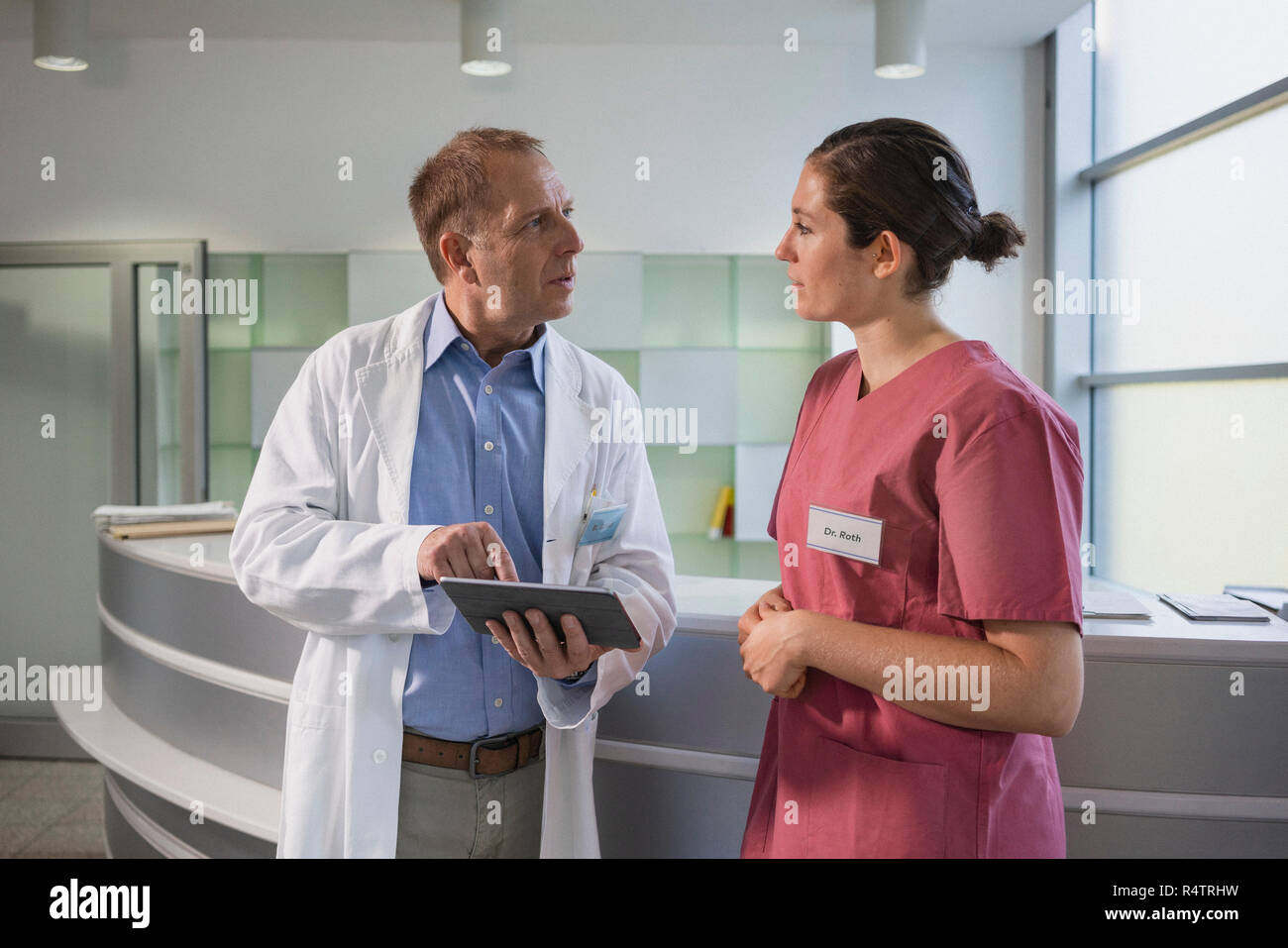 Doctors using digital tablet in hospital Stock Photo