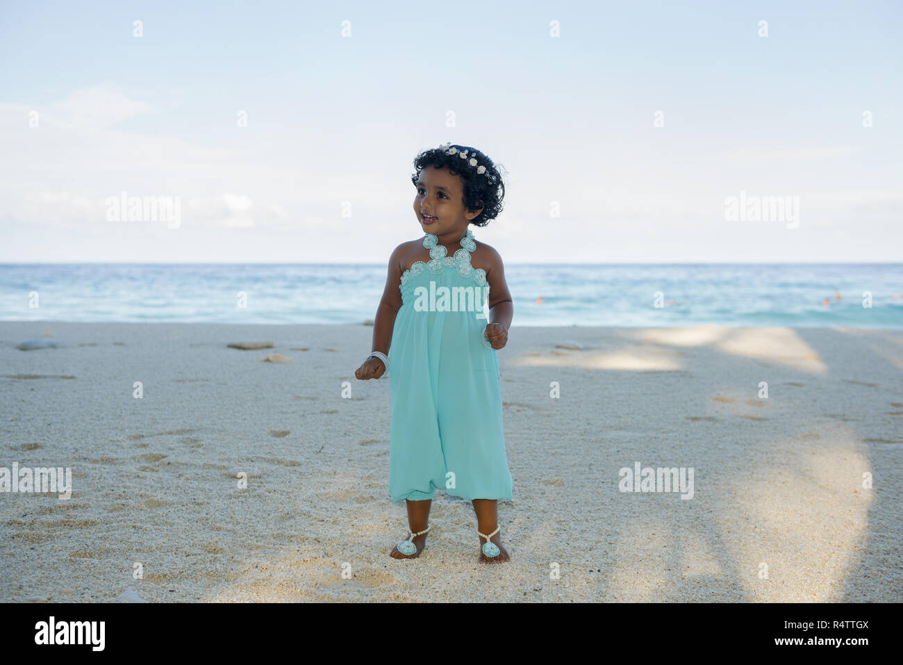 Little Maldivian girl on the sandy beach, Fuvahmulah Island, Maldives