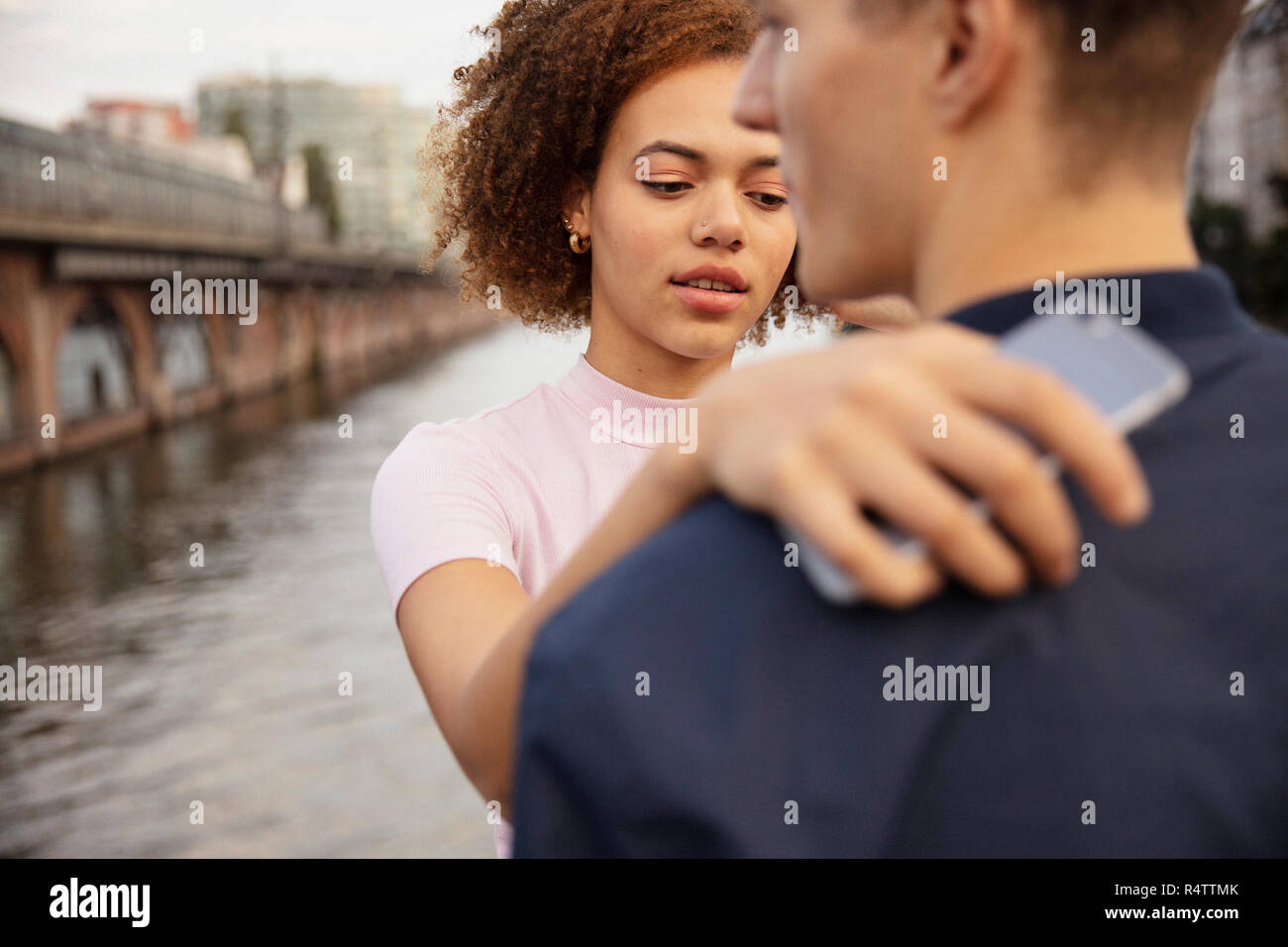 Young couple hugging at riverside Stock Photo - Alamy