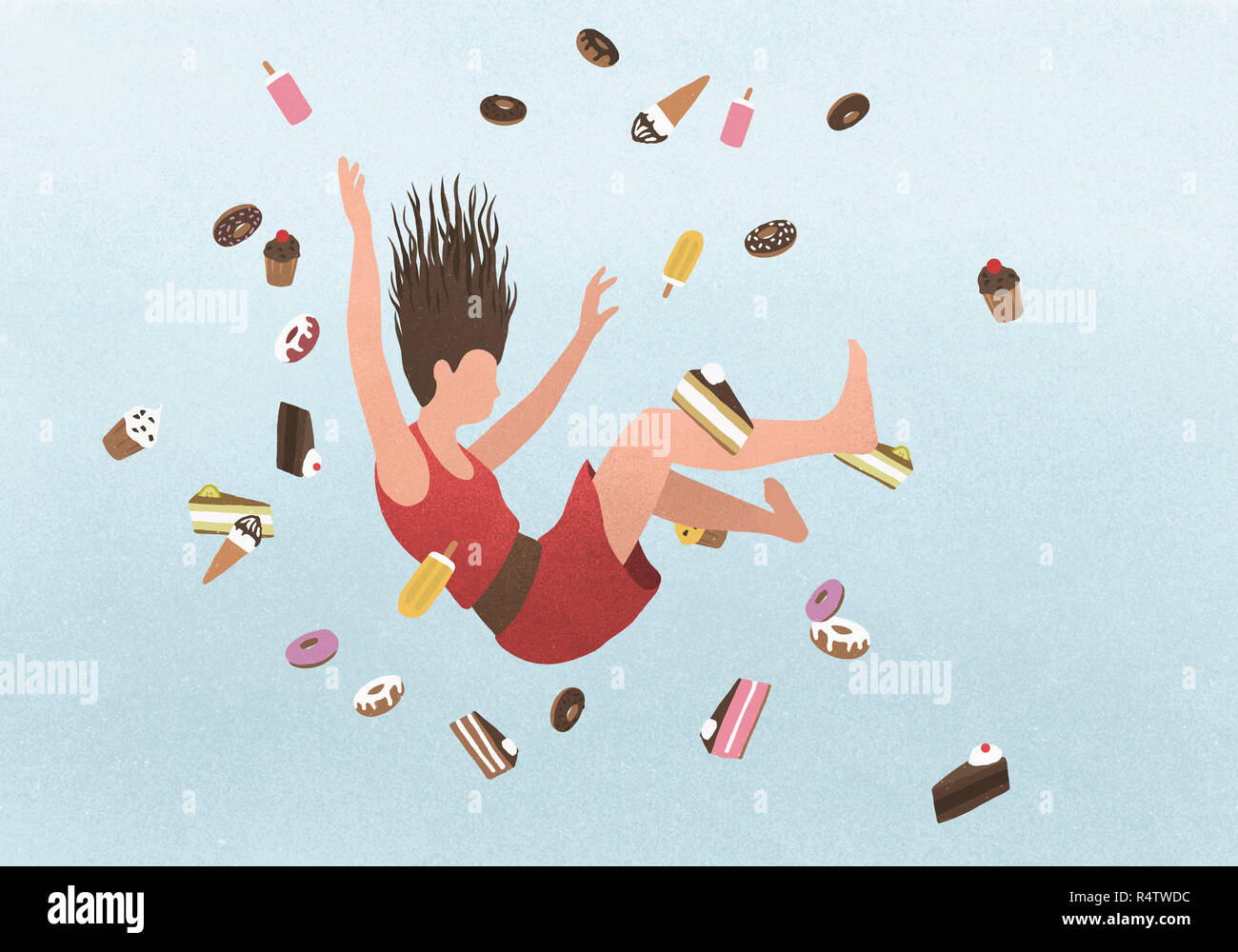 A woman falling amongst sweet junk food Stock Photo