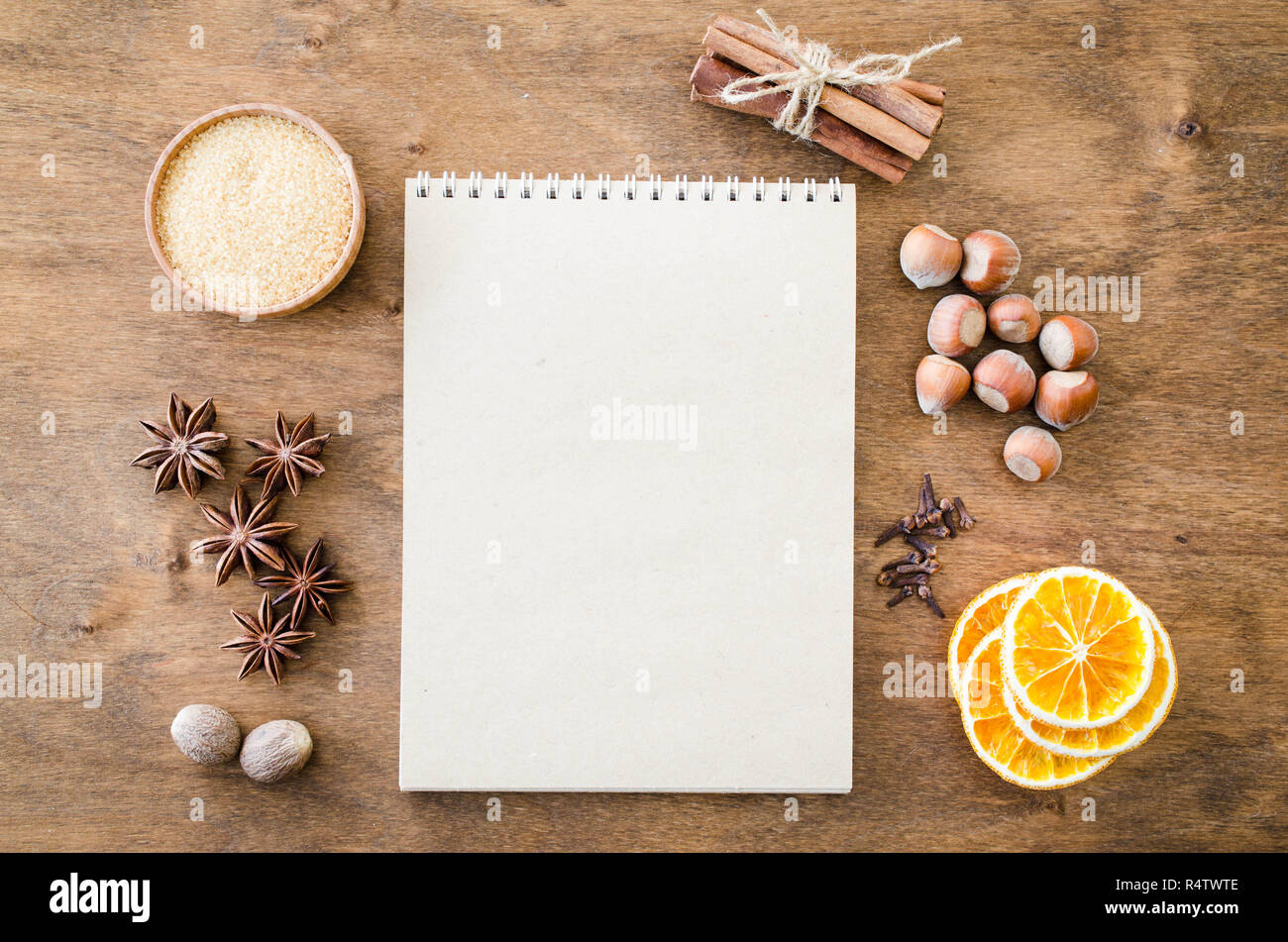 Brown notebook for writing recipe or menu on wooden table. Spices for ...