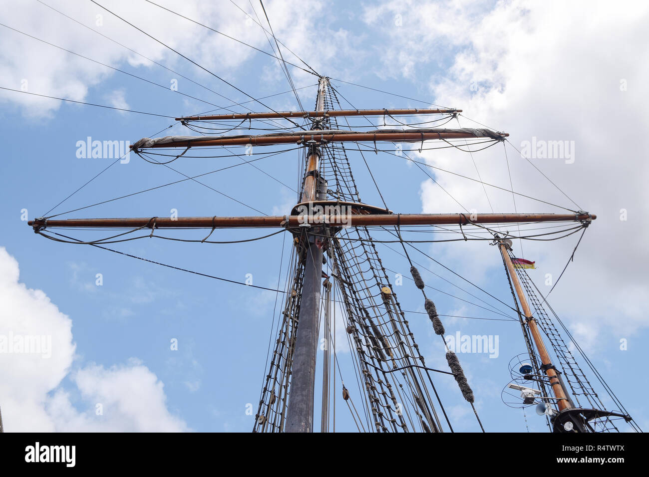 rigging and masts of an old sailing ship against the blue sky with ...