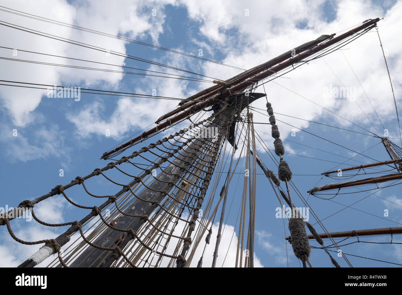 mast and rigging of an historic sailing ship against the blue sky with ...
