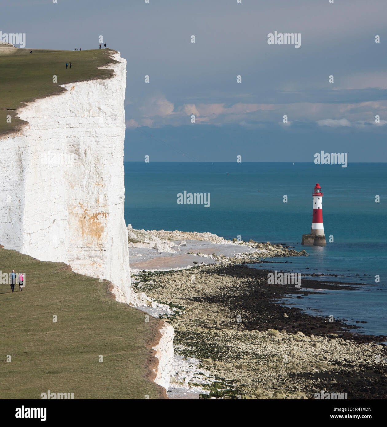 Walkers Along The Path Overlooking Beachy Head Lighthouse At
