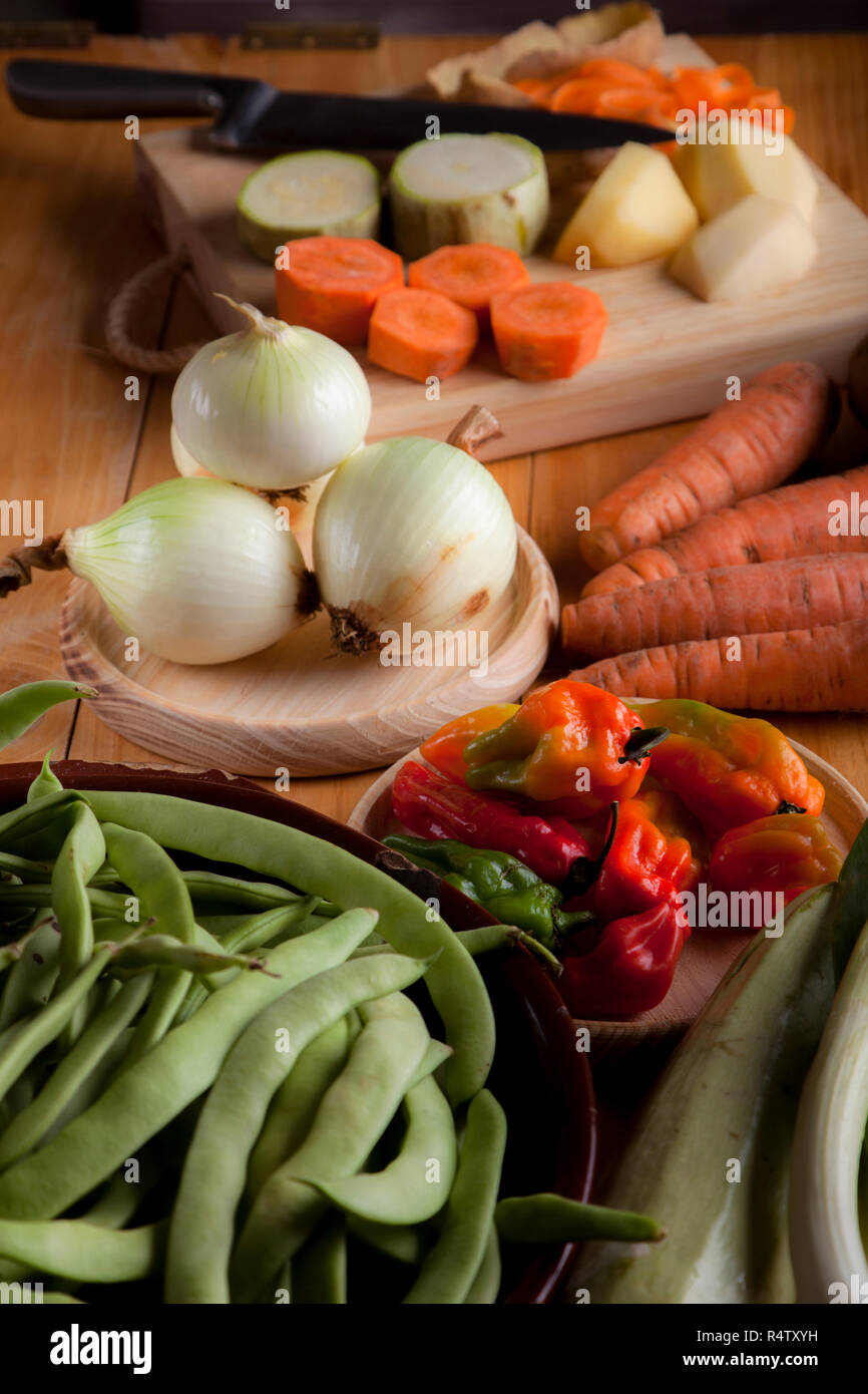 Ingredients to prepare vegan or vegetarian food, healthy food for vegan or vegetarian people, potatoes, carrots, onions, chili, beans, chives, zucchin Stock Photo