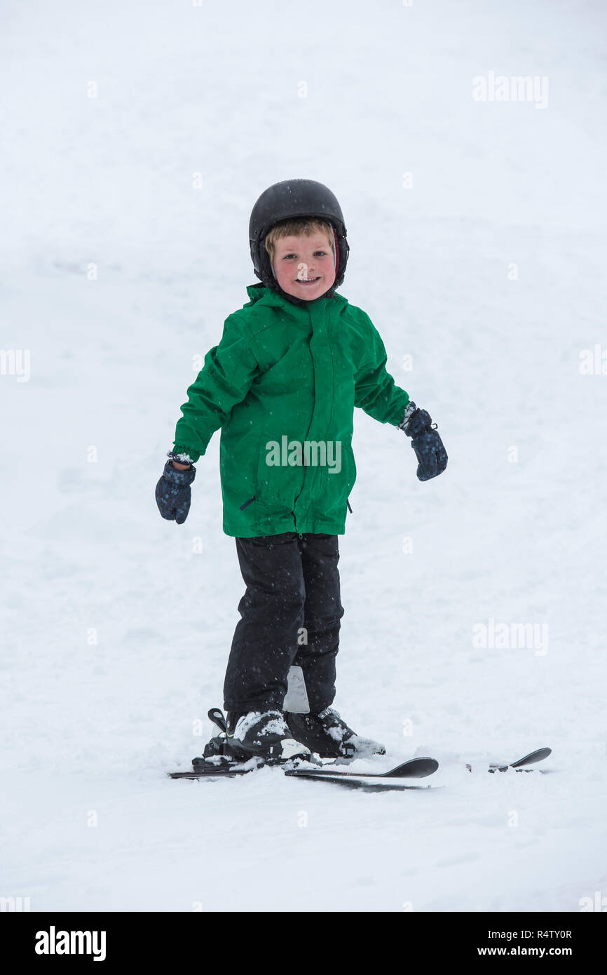 Portrait smiling, cute boy skiing in snow Stock Photo