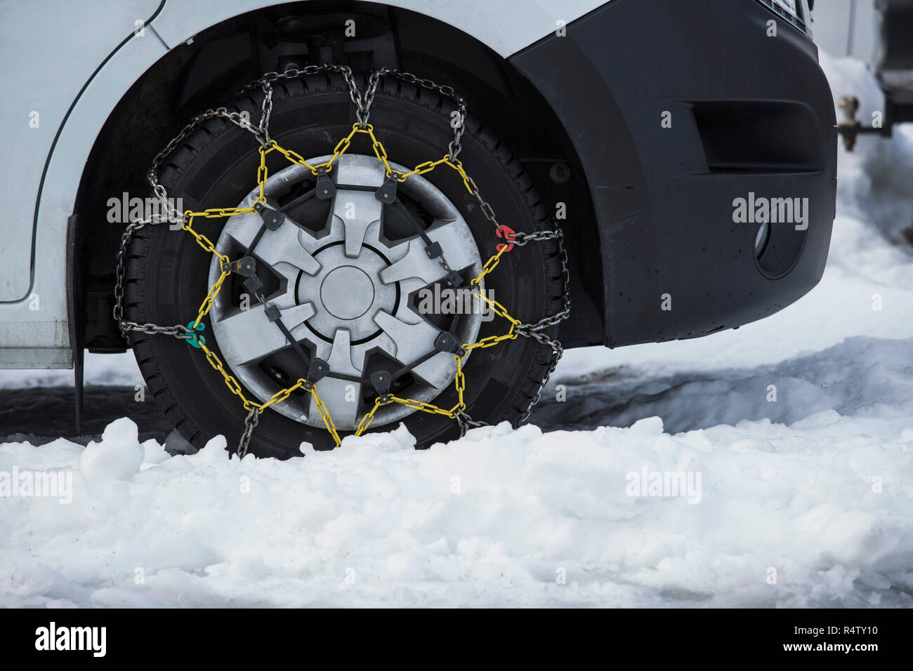 Snow chains on parked car Stock Photo Alamy