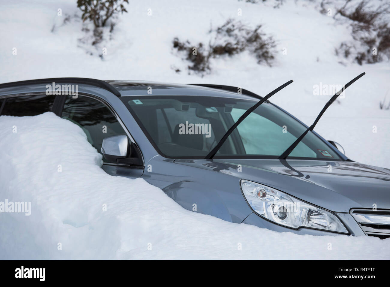 Car parked in snow with windshield wipers up Stock Photo Alamy