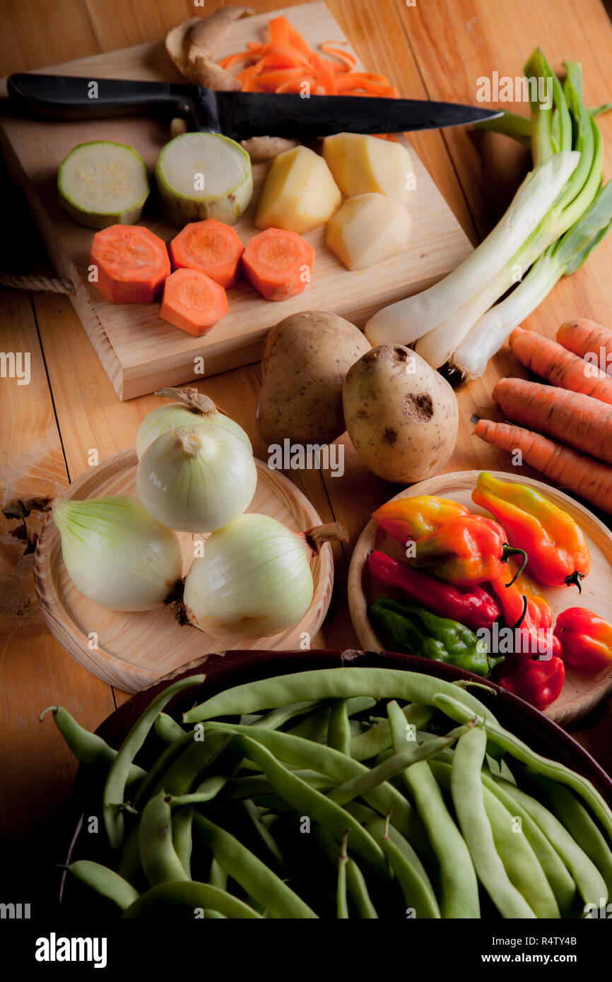 Ingredients to prepare vegan or vegetarian food, healthy food for vegan or vegetarian people, potatoes, carrots, onions, chili, beans, chives, zucchin Stock Photo