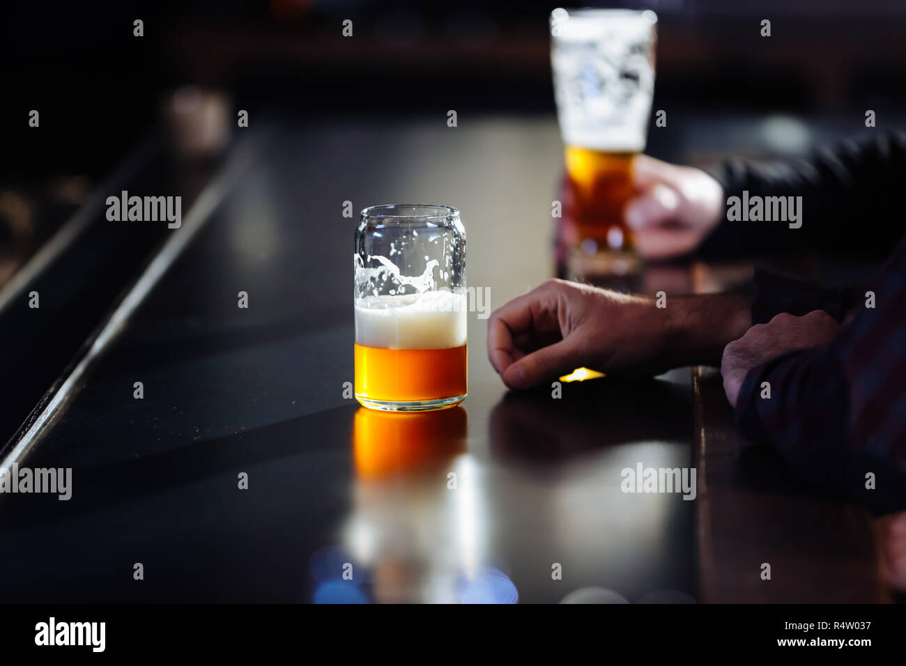 A Man Enjoying A Pint of Craft Beer At A Brew Pub Stock Photo