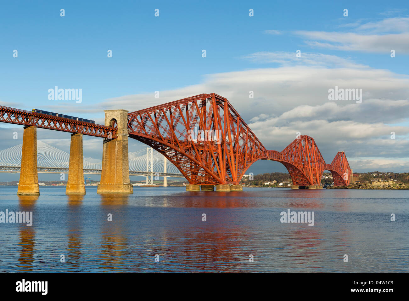 A train crossing the Forth Bridge viewed from South Queensferry, Edinburgh, Scotland Stock Photo