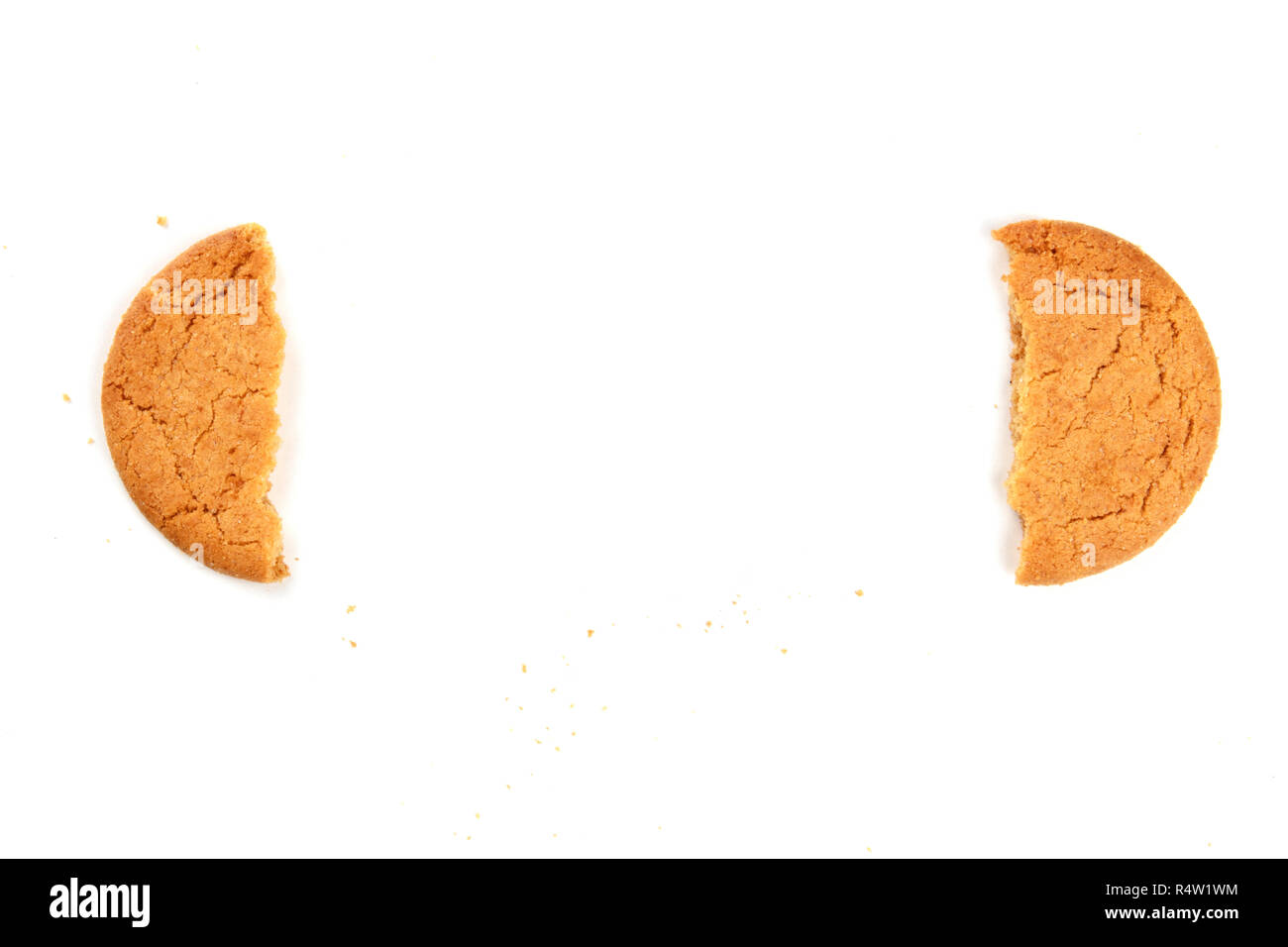 Two halves of a ginger snap cookie forming a frame for copy space, shot ...
