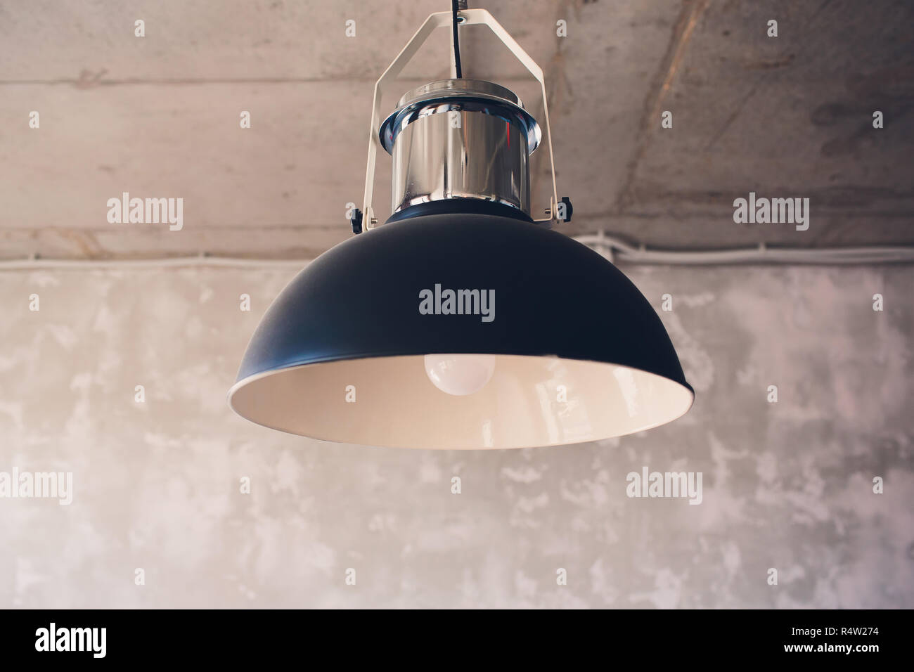 Large lamps with a metal chromeplated lampshade as part of the